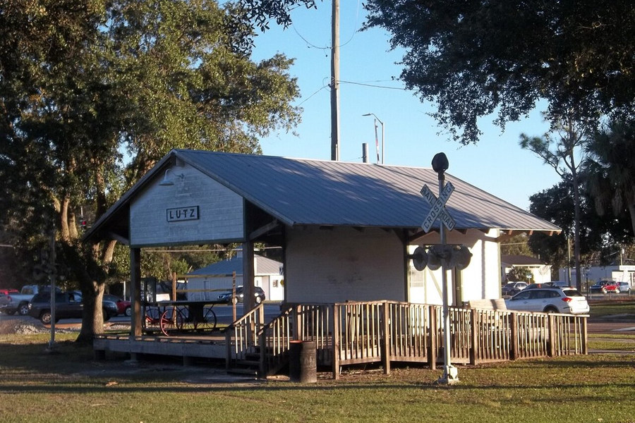 Reconstructed Lutz train depot beside a shaded lawn